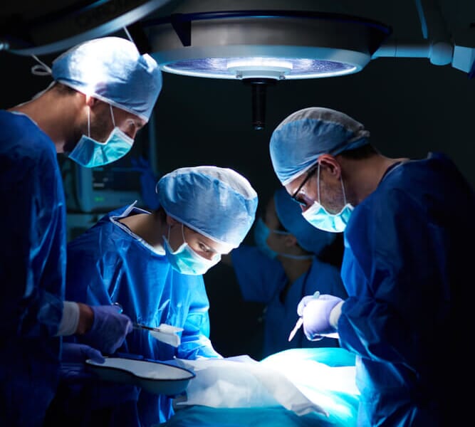 three doctors doing surgery